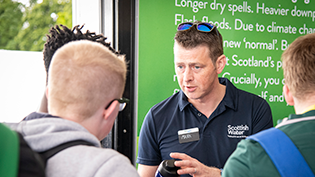 Scottish Water staff member talking to the public