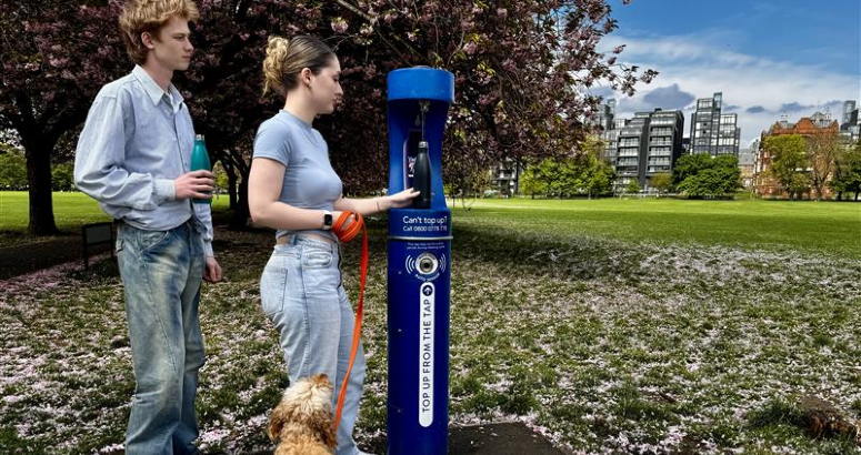 People refilling their bottle with water from a Top Up Tap