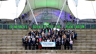 Large group on steps of Edinburgh's Dynamic Earth building, to celebrate 10 years of Learn to Swim programme