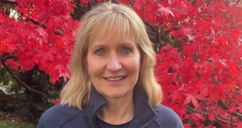 head and shoulders of Scottish Water Board Chair Deirdre Michie in front of a vibrant red leafed tree